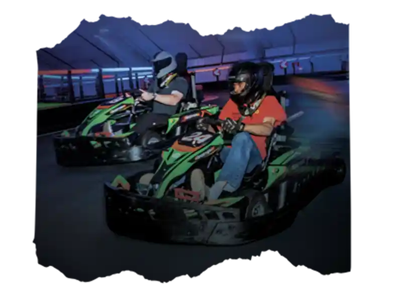 drivers racing go-karts on an indoor track
